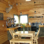 The kitchen, complete with dining area, dishwasher, gas stove, refrigerator, microwave, toaster, kitchen utensils and cook ware.