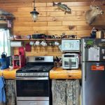 The kitchen, complete with dining area, dishwasher, gas stove, refrigerator, microwave, toaster, kitchen utensils and cook ware.